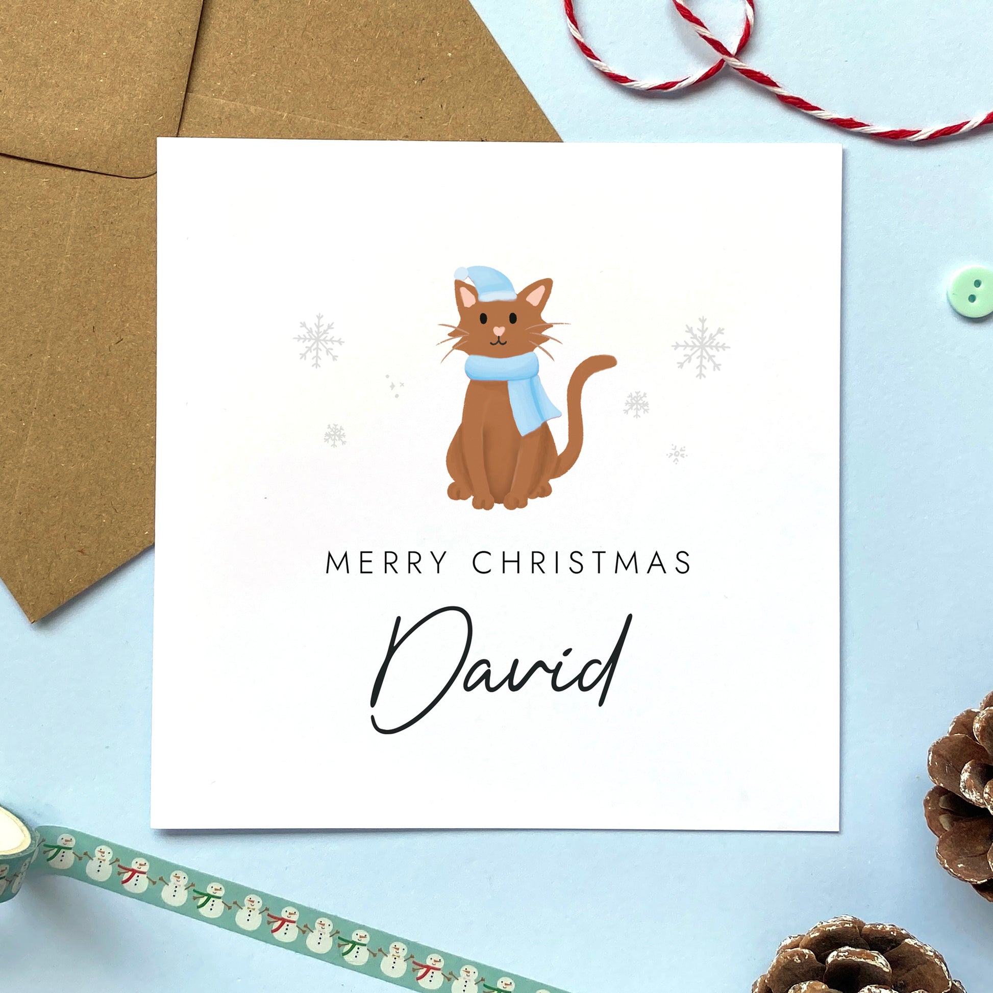 A personalised Christmas card for Him featuring a brown cat. It can be personalised by adding a name or relation. It's designed as a special Christmas card for male relations such as Son, Husband, Brother, Grandson and Dad.
