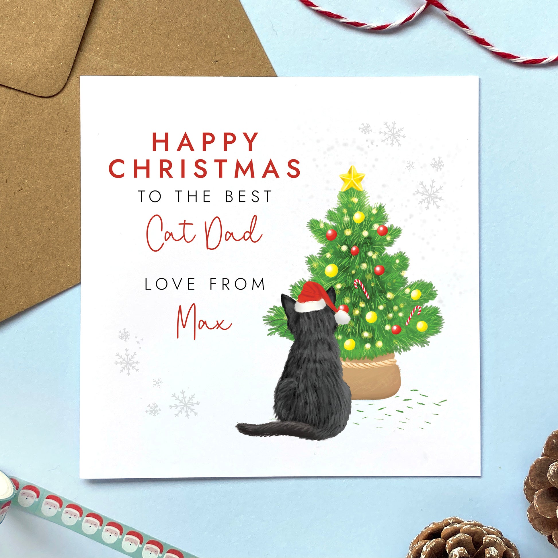 A personalised from the cat christmas card for cat dad. It can be personalised by choosing the cat on the card and the cat's name. The card in the photo is a black cat christmas card.