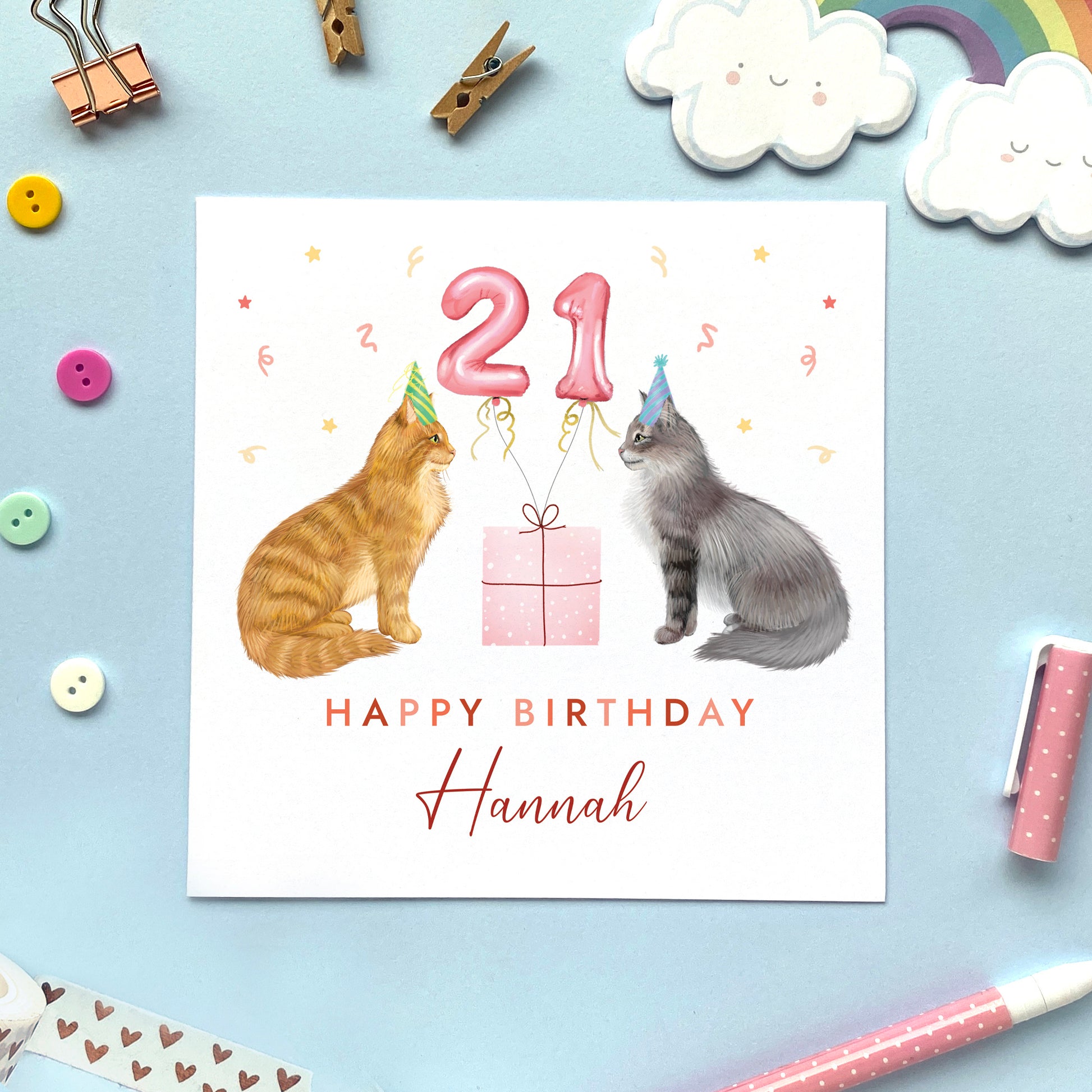 A personalised two cats birthday card for her where you can choose both cats on the card and add an age and name. The card in the photo is a 21st birthday card with a longhaired ginger cat and a longhaired grey tabby cat.