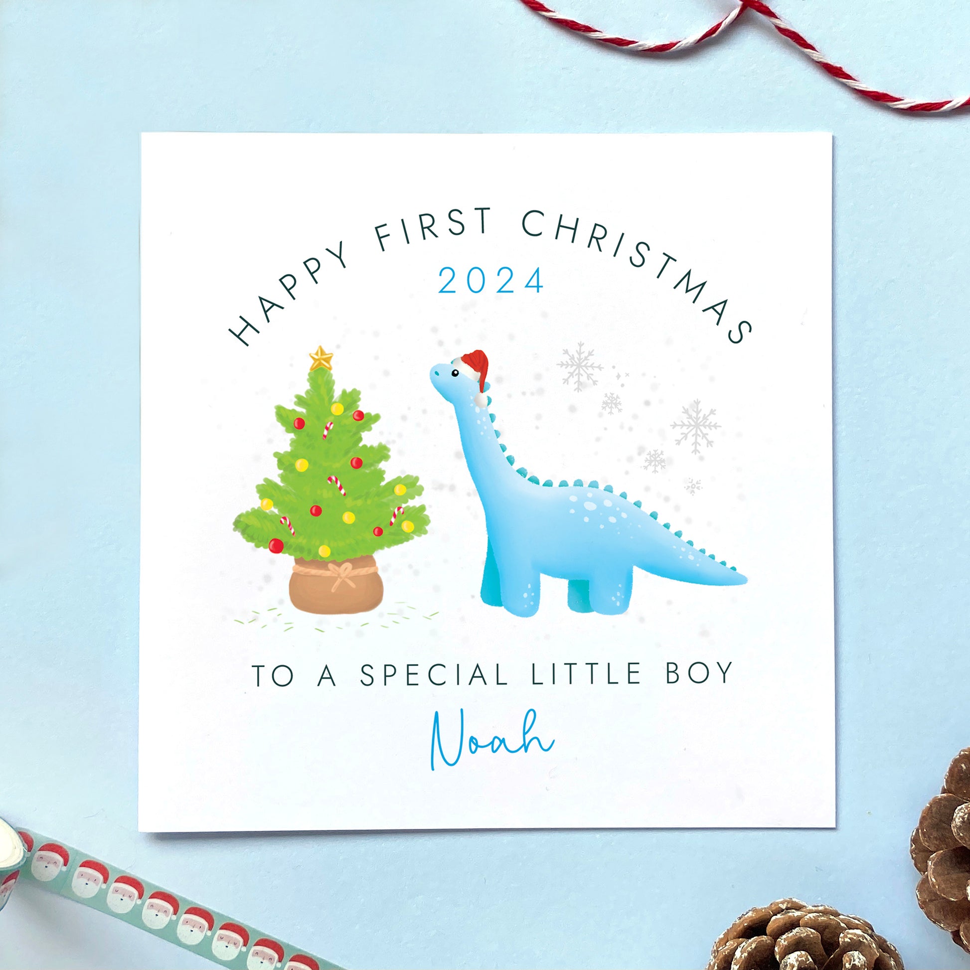 A personalised Dinosaur 1st Christmas Card for Boy, for baby's first christmas.