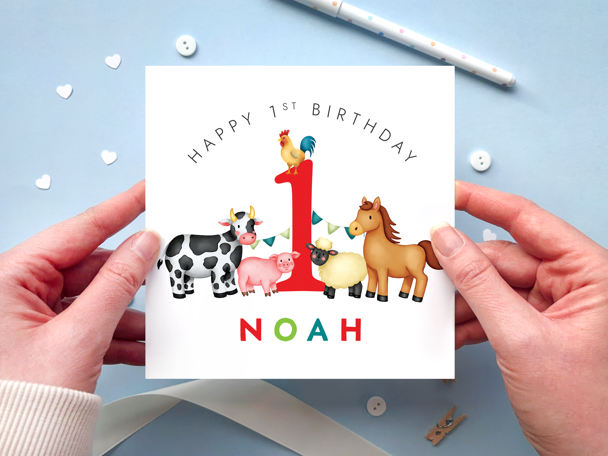 A bold and bright farm themed 1st birthday card for boys. It features a sheep, pig, cow, horse and chicken, around the number one. It can be personalised with the child's name.