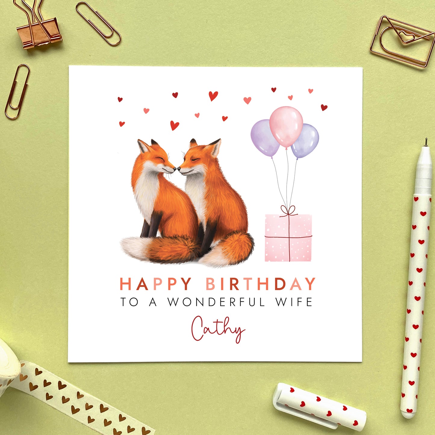 A personalised birthday card for her featuring a fox couple. It can be personalised with any relation, age and name. The card in the photo is a birthday card for Wife.