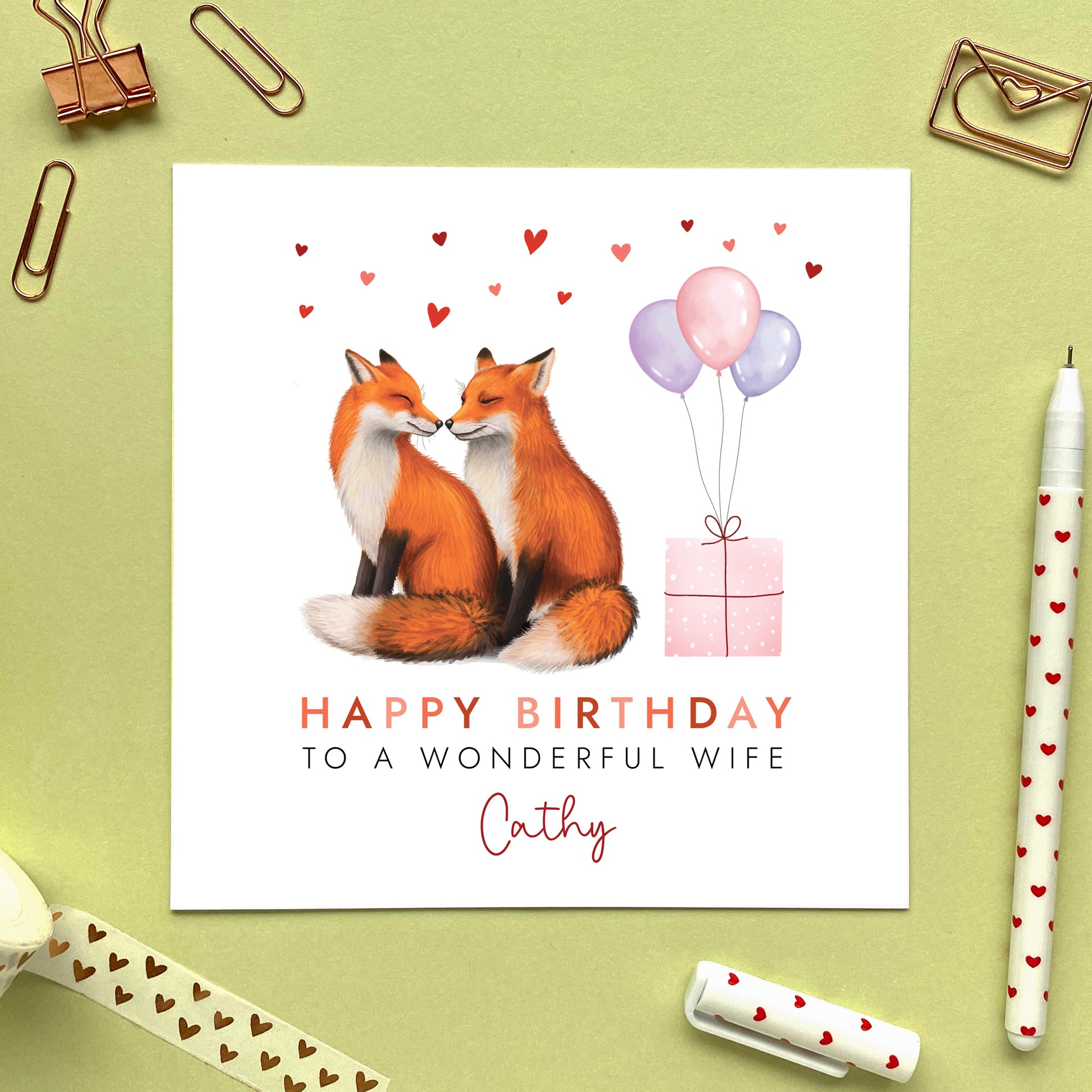 A personalised birthday card for her featuring a fox couple. It can be personalised with any relation, age and name. The card in the photo is a birthday card for Wife.