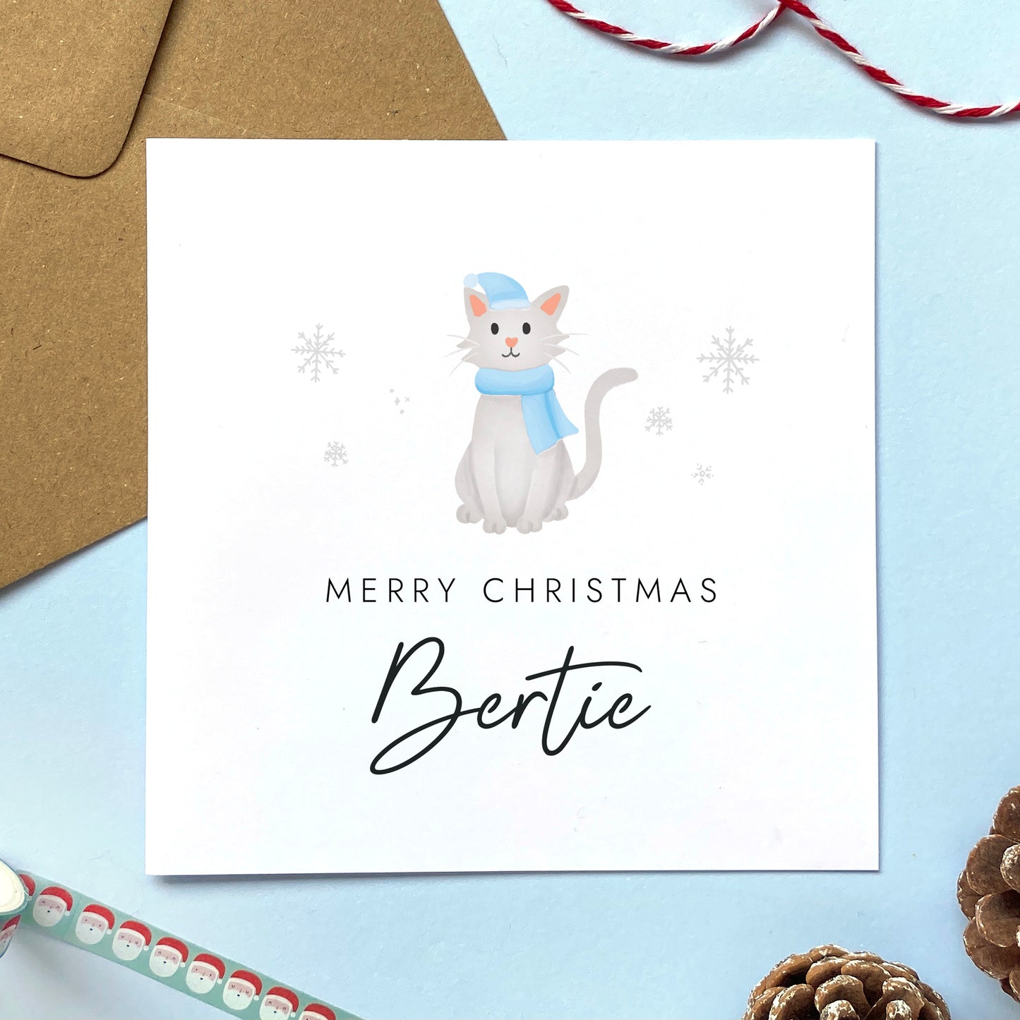 A personalised Christmas card for Him featuring a light grey cat. It can be personalised by adding a name or relation. It's designed as a special Christmas card for male relations such as Son, Husband, Brother, Grandson and Dad.