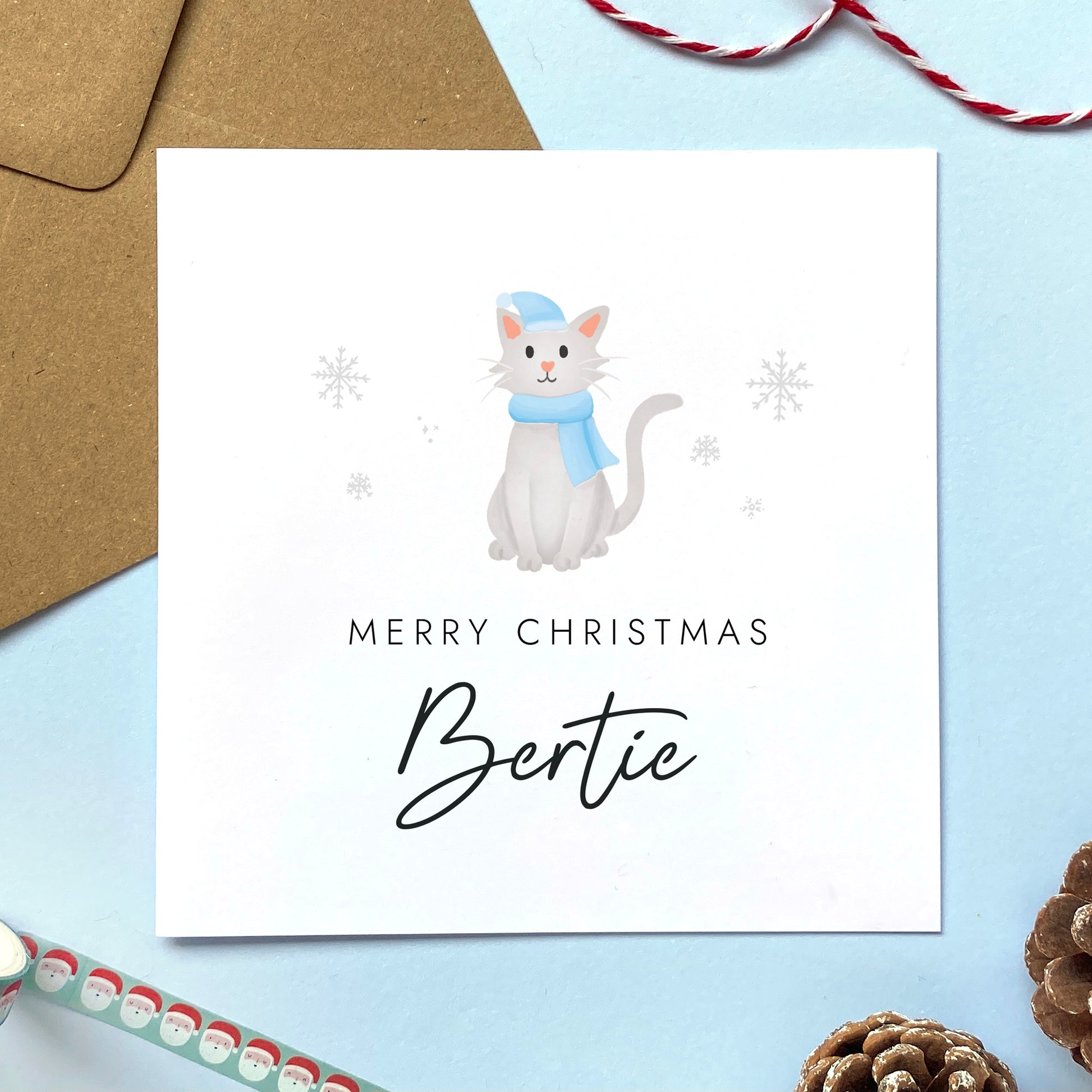 A personalised Christmas card for Him featuring a light grey cat. It can be personalised by adding a name or relation. It's designed as a special Christmas card for male relations such as Son, Husband, Brother, Grandson and Dad.