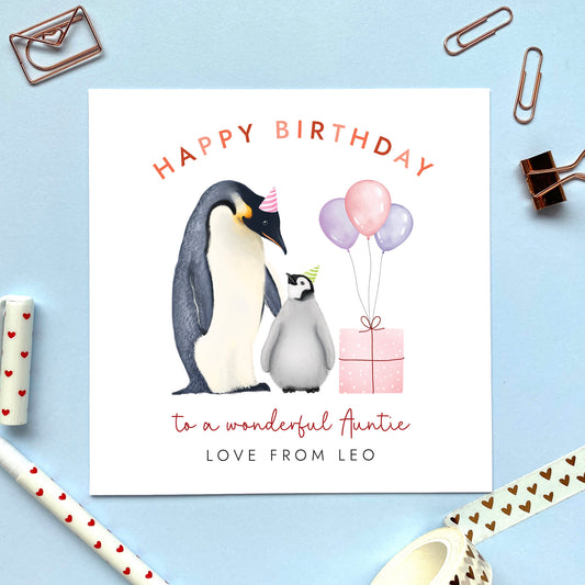 A personalised penguins birthday card for Auntie. It features a cute design with an adult penguin looking over a baby penguin, with a pink present and purple and pink balloons. The balloons can be changed to an age such as 30th, 40th or 50th. It's suitable for any Auntie including Aunty, Aunt and Great Auntie. It can be personalised with a child's name from Niece or Nephew.