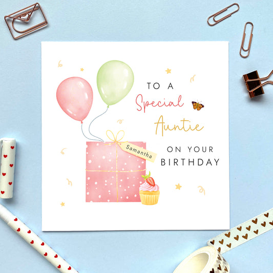 A special personalised birthday card for Auntie, featuring a pink present, pink and green balloons, and a strawberry cupcake. It's suitable for any Aunt, Aunty or Great Auntie. The age can be changed to any number, such as 18th, 21st, 30th, 40th and 50th.