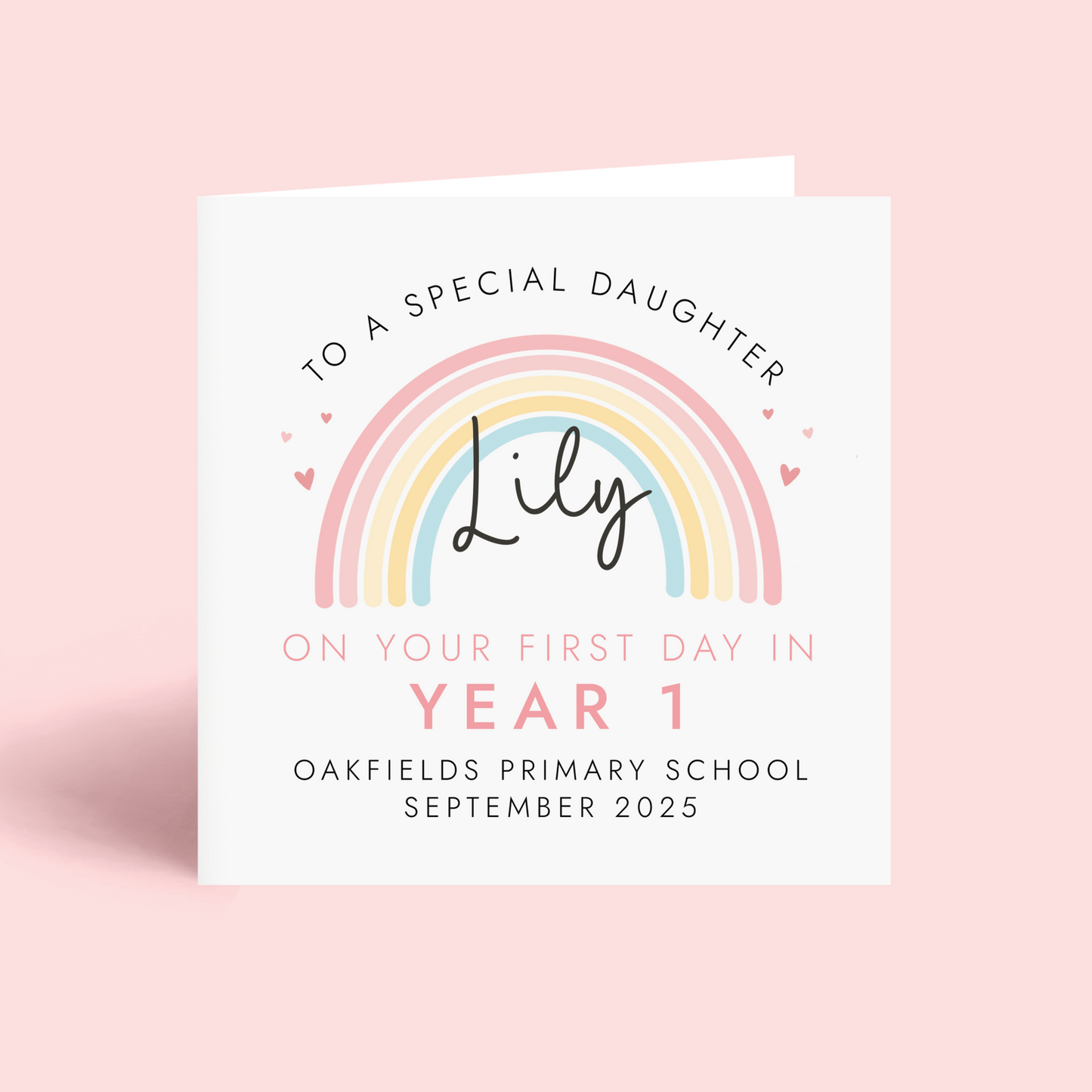 Personalised pink pastel rainbow card for starting a new school term. Add any girl's name, school name and starting date. The card in the photo is a first day in year 1 card for daughter.