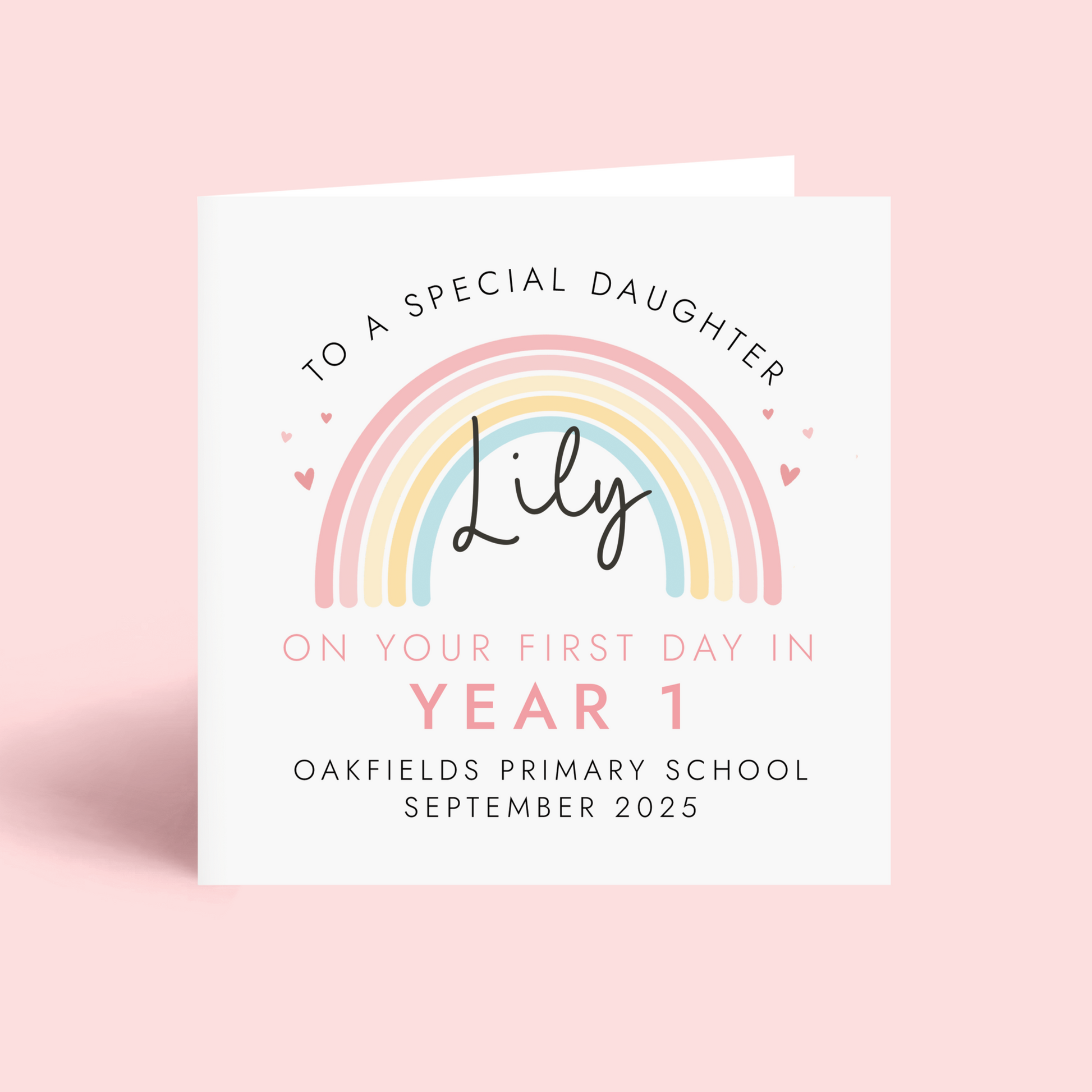 Personalised pink pastel rainbow card for starting a new school term. Add any girl's name, school name and starting date. The card in the photo is a first day in year 1 card for daughter.