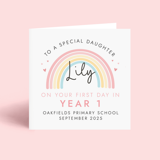 Personalised pink pastel rainbow card for starting a new school term. Add any girl's name, school name and starting date. The card in the photo is a first day in year 1 card for daughter.