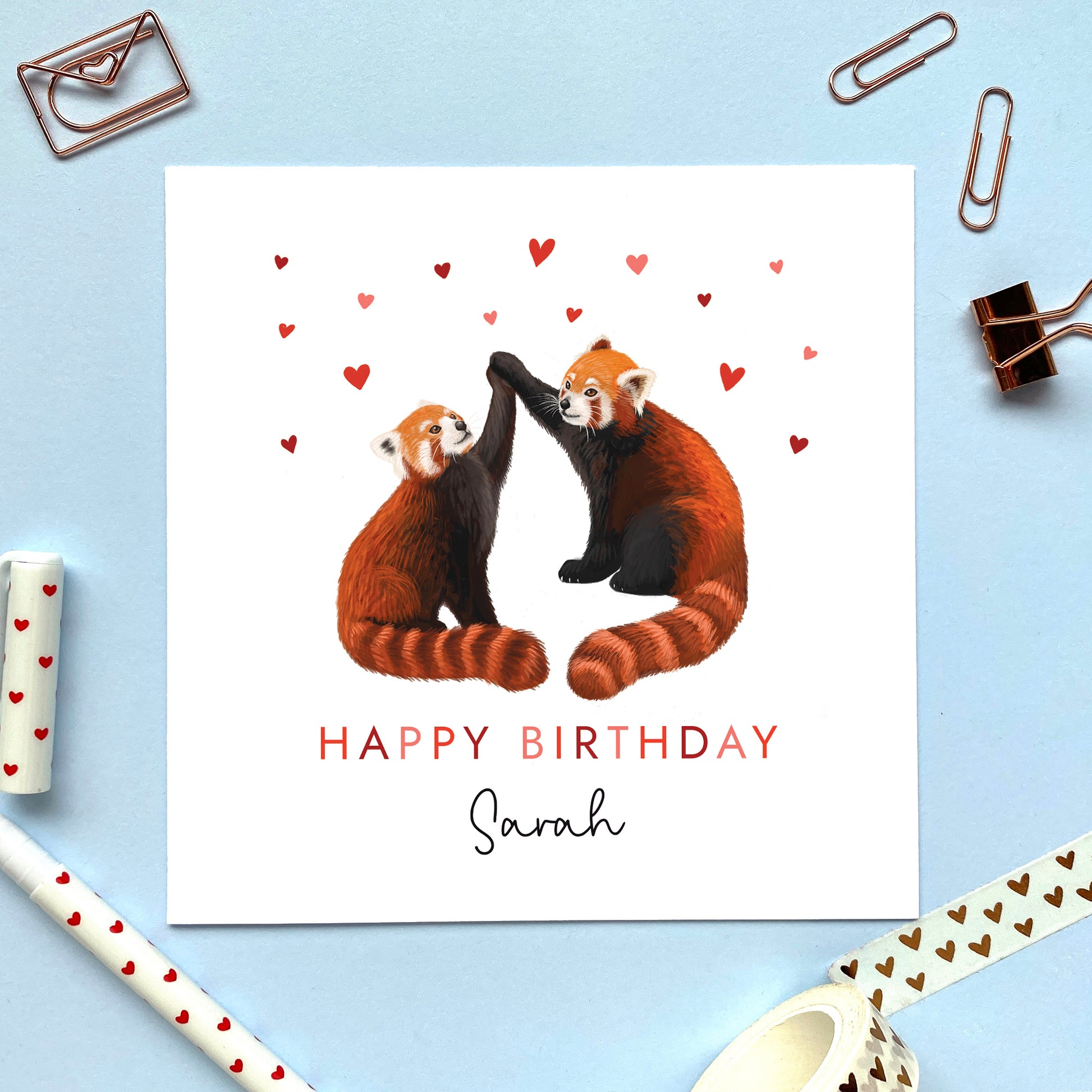 A personalised birthday card for partner featuring a pair of red pandas with hearts. It can be personalised with a name and is suitable for both him and her. Ideal for husband, wife, fiance, fiancee, boyfriend and girlfriend.