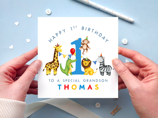 Personalised 1st birthday card for Grandson featuring bright and colourful safari animals, around the number 1