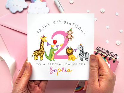 A personalised safari themed 2nd birthday card for girls, featuring illustrations of jungle animals - giraffe, crocodile, lion, zebra and monkey - around the number 2, in bright and bold colours