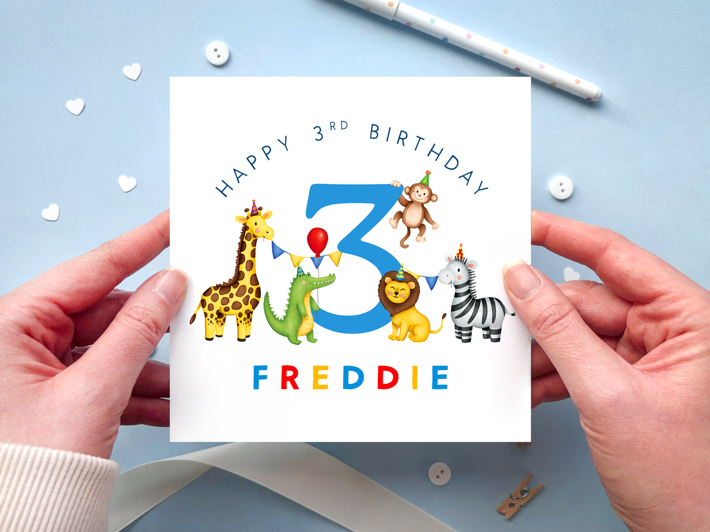 A personalised safari themed 3rd birthday card for boys, featuring illustrations of jungle animals - giraffe, crocodile, lion, zebra and monkey - around the number 3, in bright and bold colours