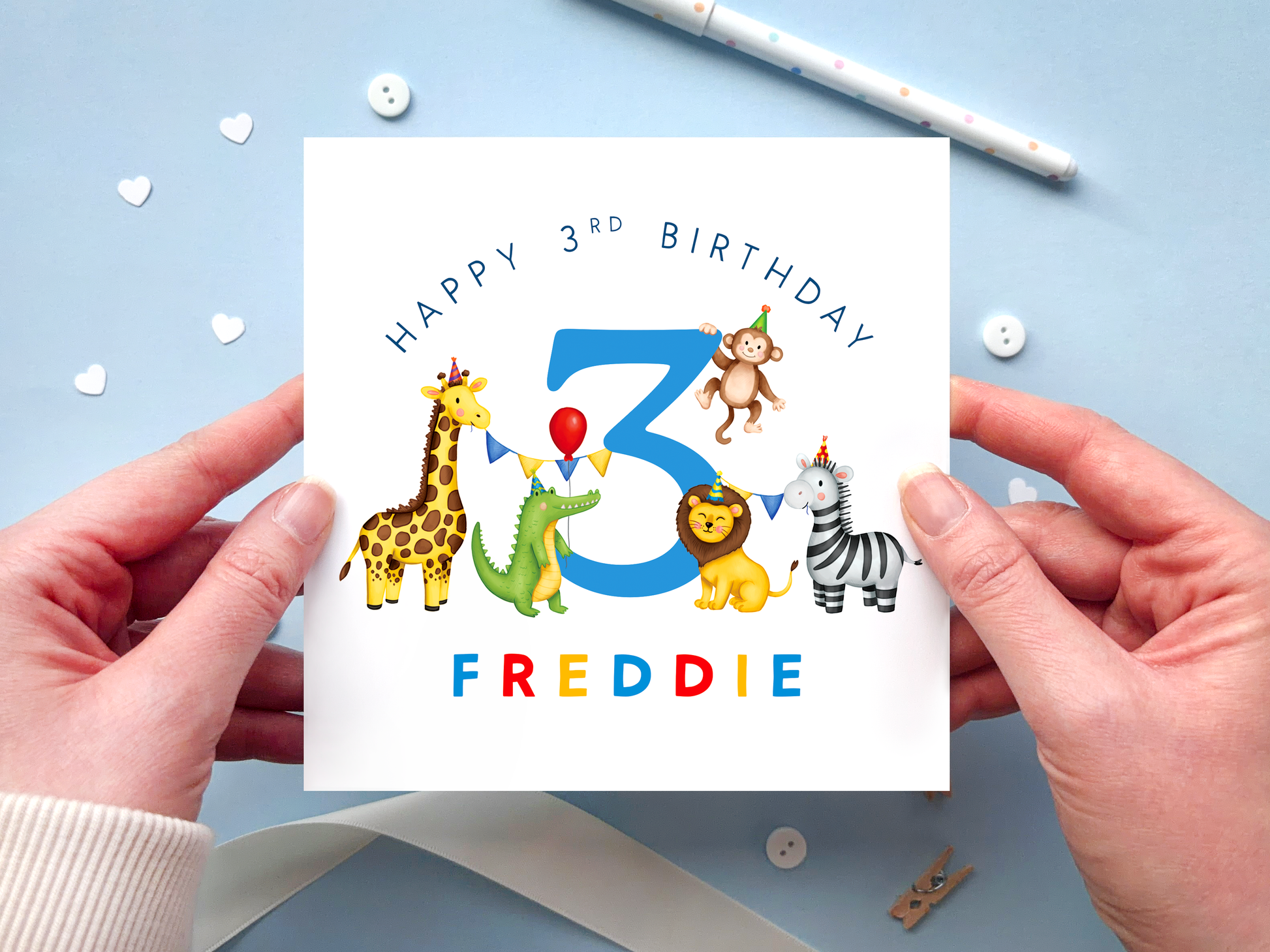 A personalised safari themed 3rd birthday card for boys, featuring illustrations of jungle animals - giraffe, crocodile, lion, zebra and monkey - around the number 3, in bright and bold colours