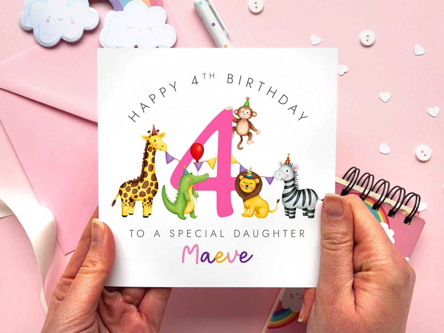 A personalised safari themed 4th birthday card for girls, featuring illustrations of jungle animals - giraffe, crocodile, lion, zebra and monkey - around the number 4, in bright and bold colours