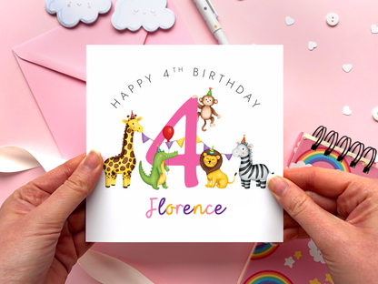 A personalised safari themed 4th birthday card for girls, featuring illustrations of jungle animals - giraffe, crocodile, lion, zebra and monkey - around the number 4, in bright and bold colours