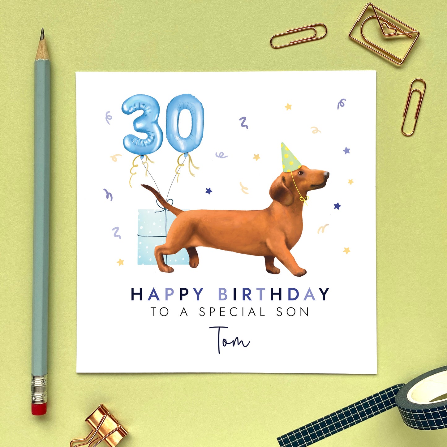 A personalised dog birthday card for him featuring a sausage dog (Dachshund). It can be personalised with any name and age. The card in the photo is a 30th birthday card for son.