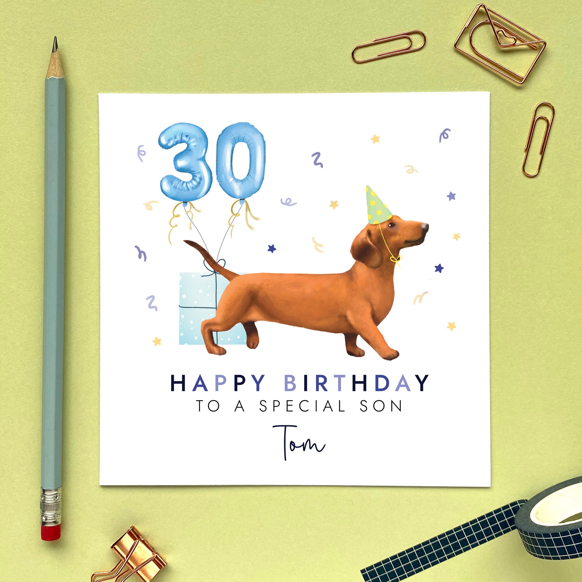 A personalised dog birthday card for him featuring a sausage dog (Dachshund). It can be personalised with any name and age. The card in the photo is a 30th birthday card for son.